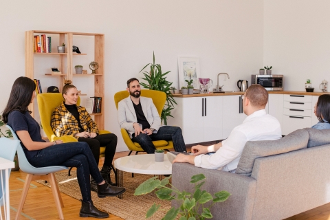 People talking while seated in a circle in an office environment